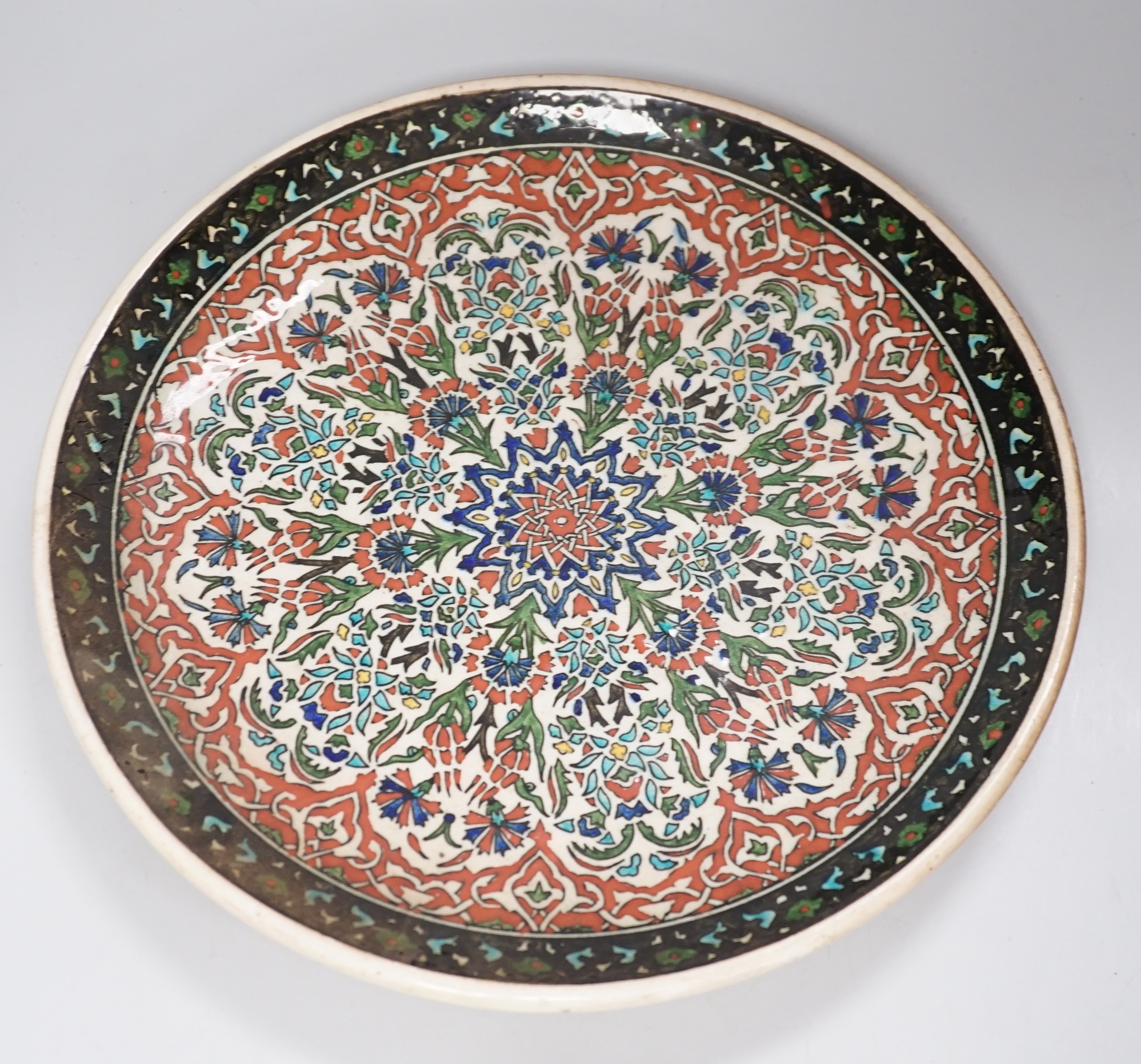 A Kütahya pottery dish, the back marked Azim Kütahya, diameter 31cm